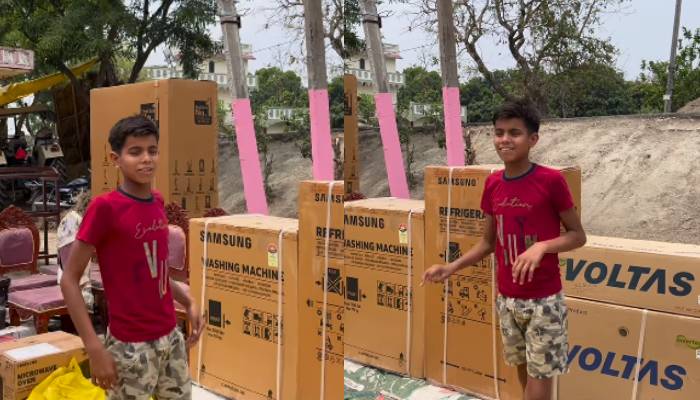 boy shows items arranged for sisters tilak ceremony 