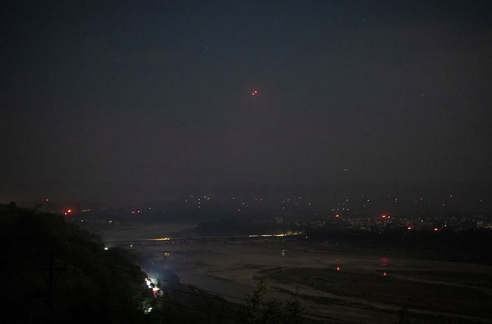 India's air defence system intercepts objects in the sky during a blackout following multiple blasts in the city of Jammu
