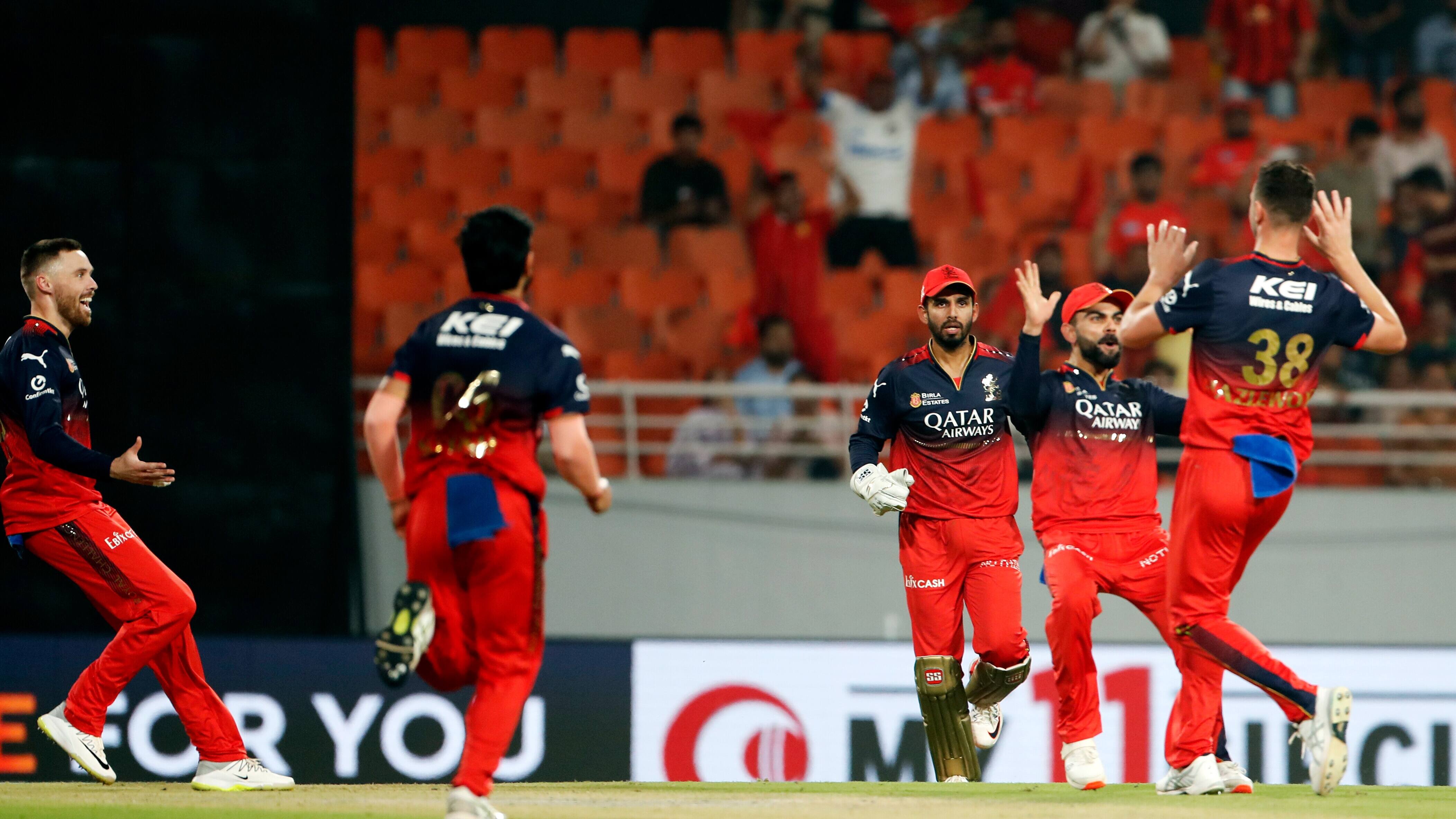 Royal Challengers Bengaluru's Virat Kohli and Josh Hazlewood celebrate the dismissal of Punjab Kings' Josh Inglis