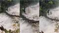 Man Crosses Raging River through rope of hanging bridge