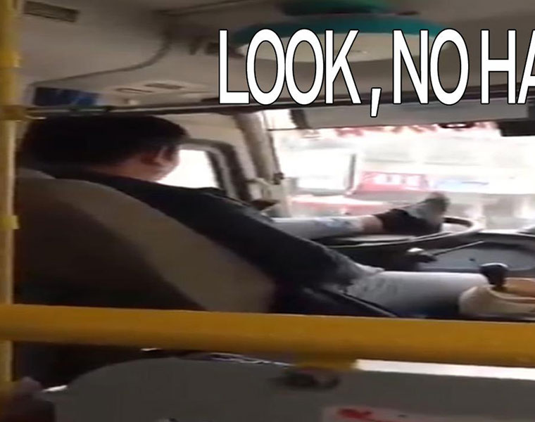 chinese bus driver using foots on steering wheel