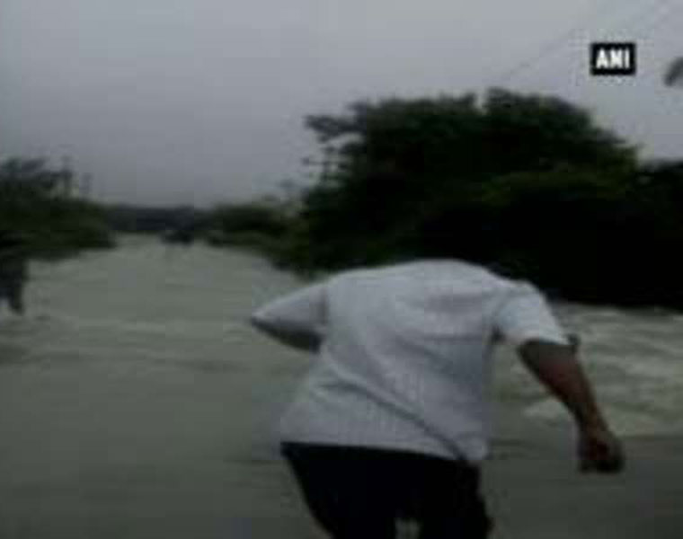 Flood water sweeps away biker