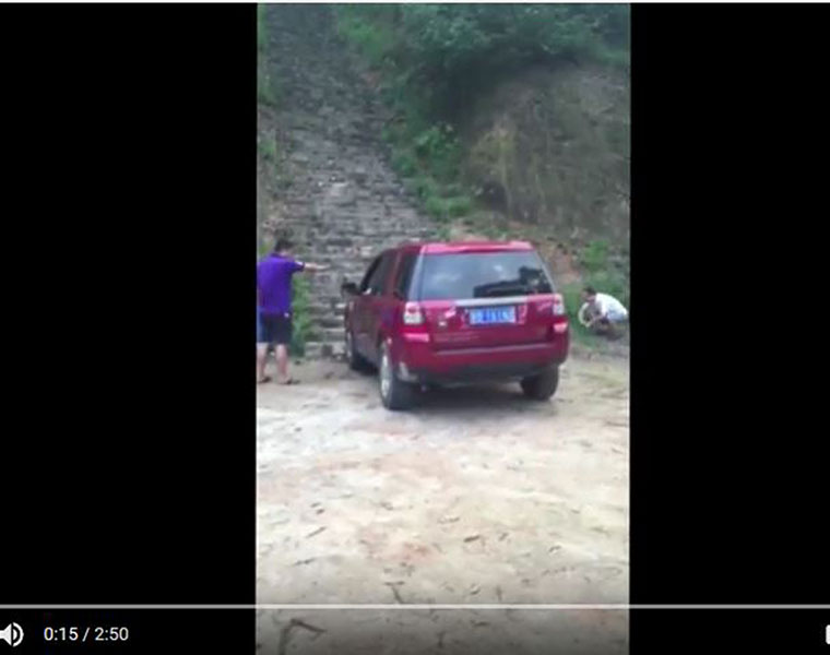 Man driving Range Rover up the stairs