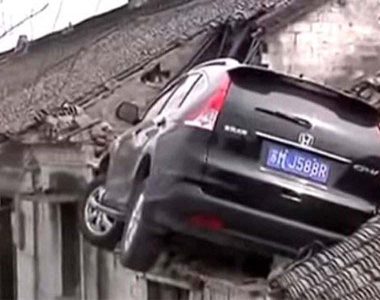 Dramatic Moment Car Parked On Roof Of House After Crash in China