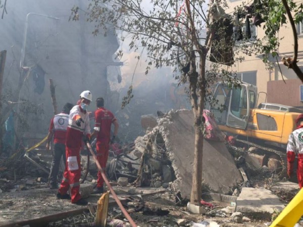 Rescuers work at the site of a damaged building, in the aftermath of Israeli strikes in Tehran, Iran, June 13 (Photo/Reuters)