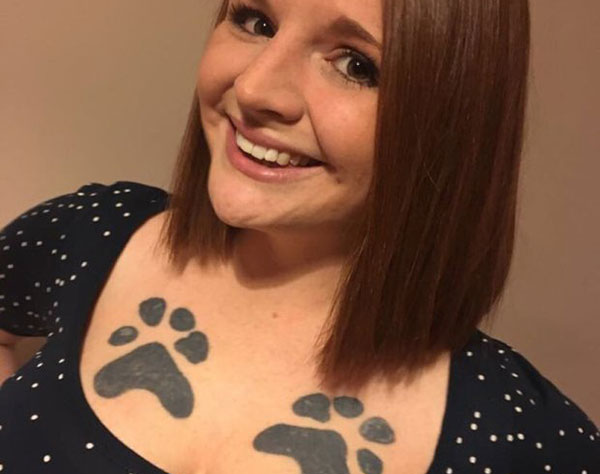 Woman who got her dead dogs paw prints tattooed on her breasts