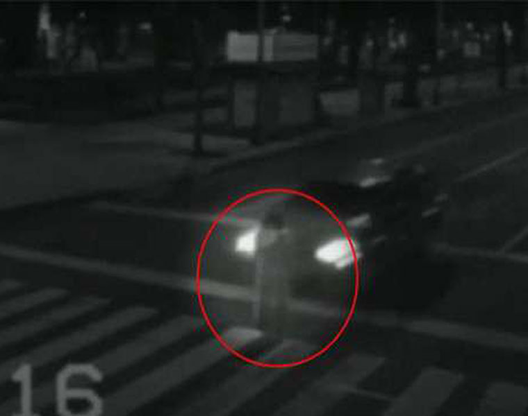 Ghost of young girl stands in the middle of zebra crossing